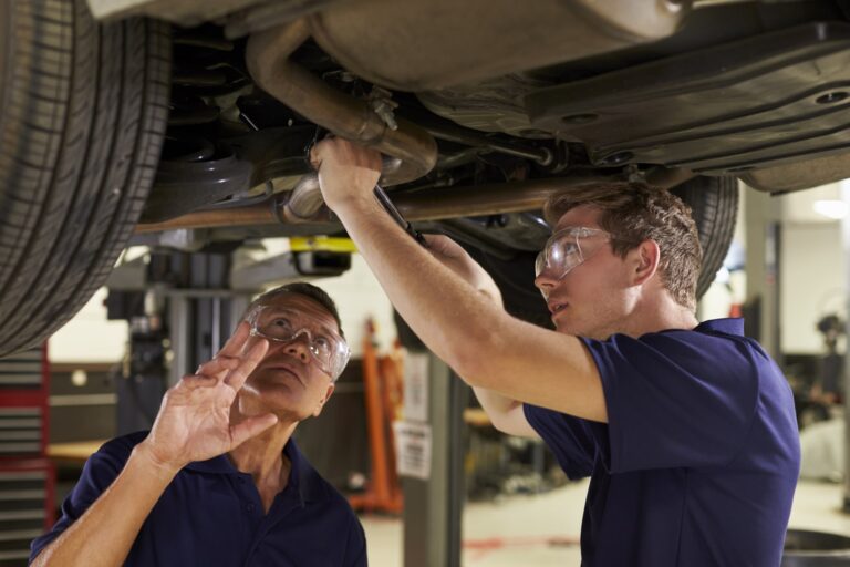 Mechanics working on car