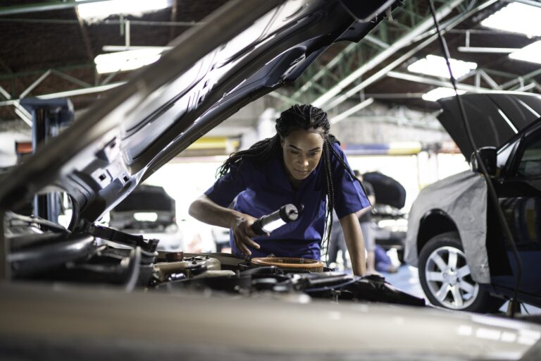 Woman working on a car